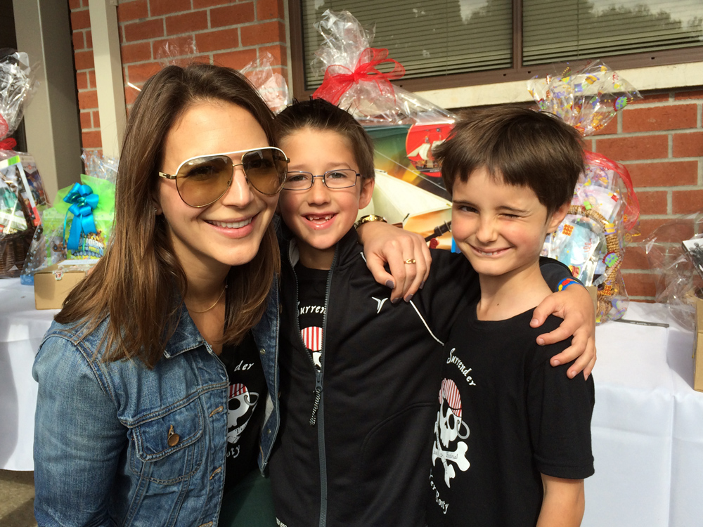 A photo with Ethan's first grade teacher Ms. Pacini and buddy Conor at the SMT School Carnival